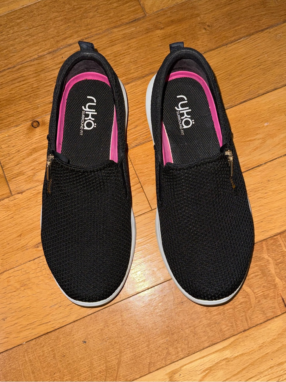 Ryka Ally slip-on sneakers featuring a black knit upper and leopard trim
